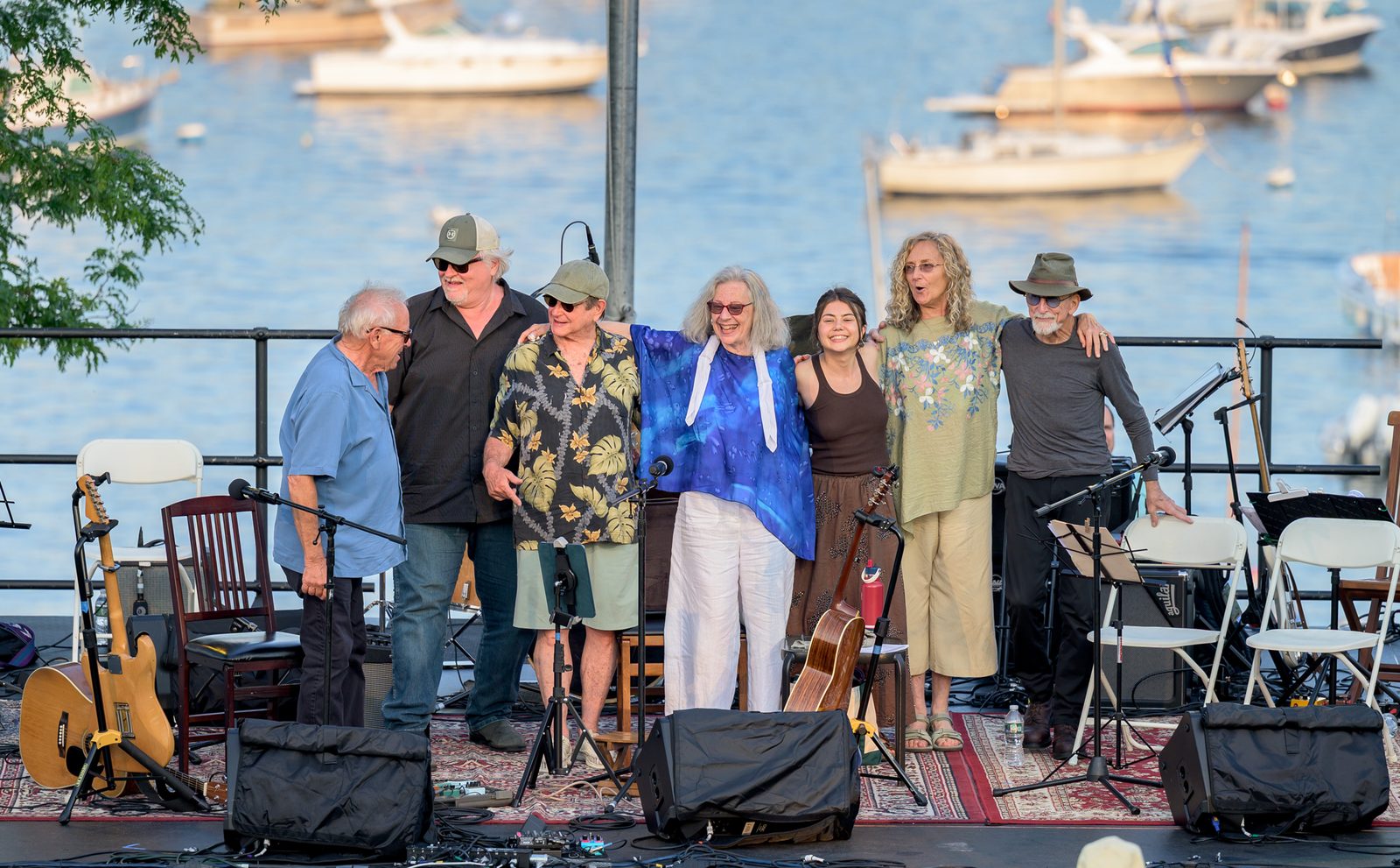 Mason Daring, Jeanie Stahl and their bandmates link arms and share a laugh at the close of their set on the Crocker Park stage.