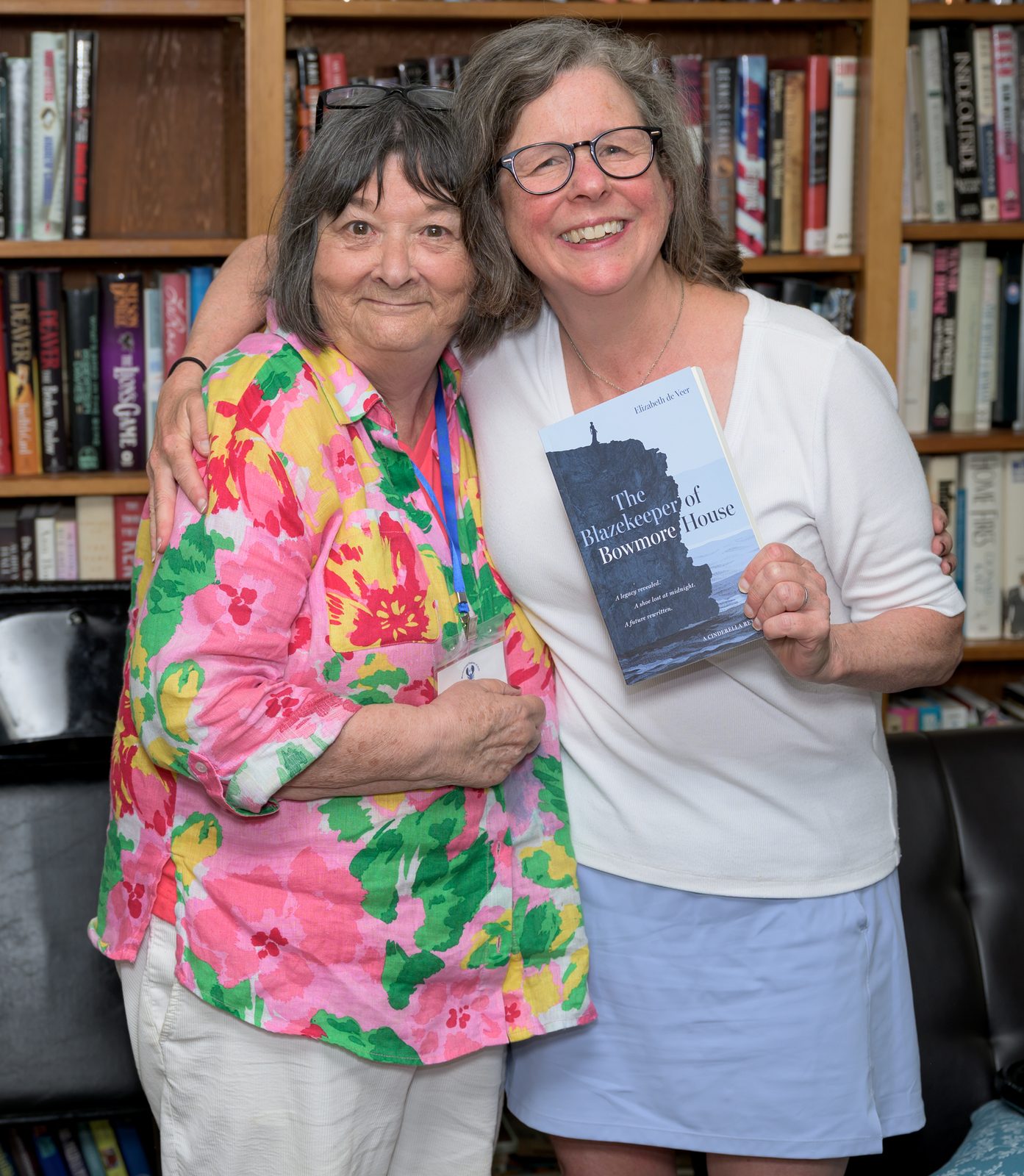 Margo Steiner, chair of the Literary Festival, embraces author Elizabeth de Veer during the literary festivities.
