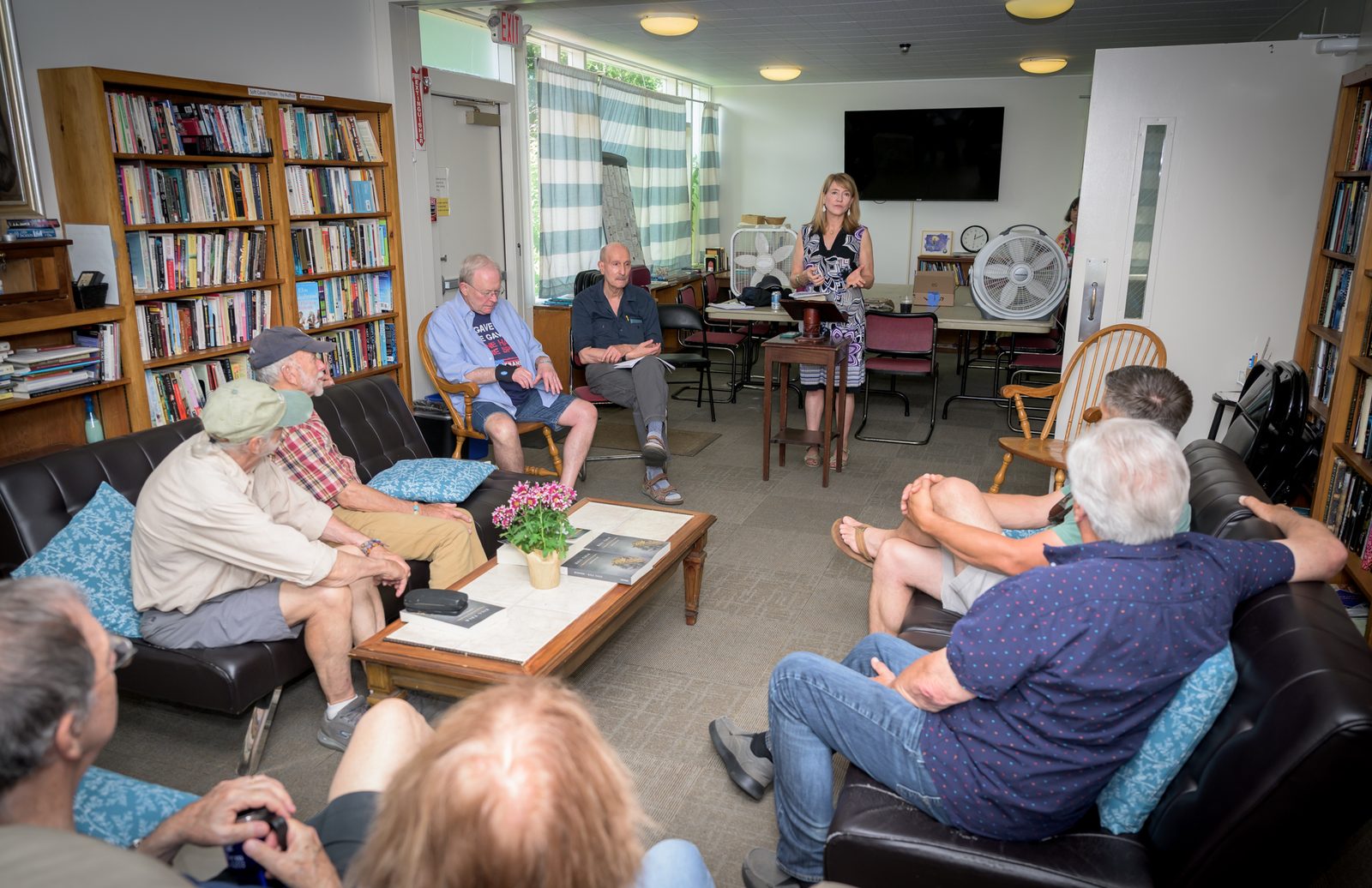 Janet McIntosh leads a session on the literature of the Vietnam War as listeners fill the couches of a book-lined room.
