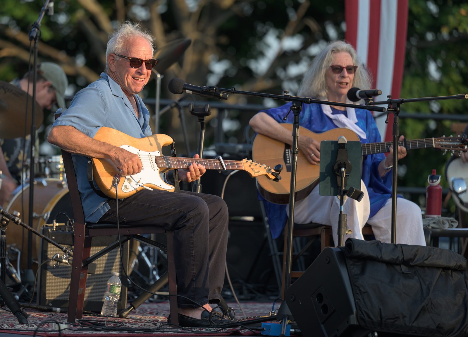 Mason Daring grins mid-song as Jeanie Stahl sings beside him during their evening set at Crocker Park.