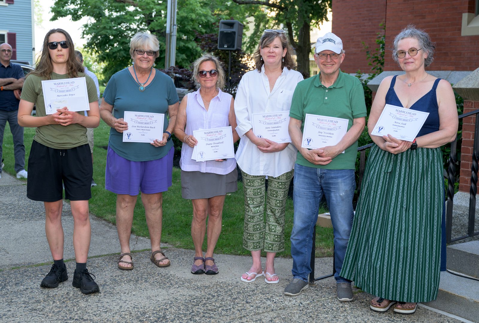 Crafts category winners hold their certificates outside Abbot Hall — Mercedes Joyce, Lisa Richardson-Bach (Carol J. Moore Award), Diane Treadwell (Best of Show), Jane Saunders, Jay Worthen and Nora Tulk.