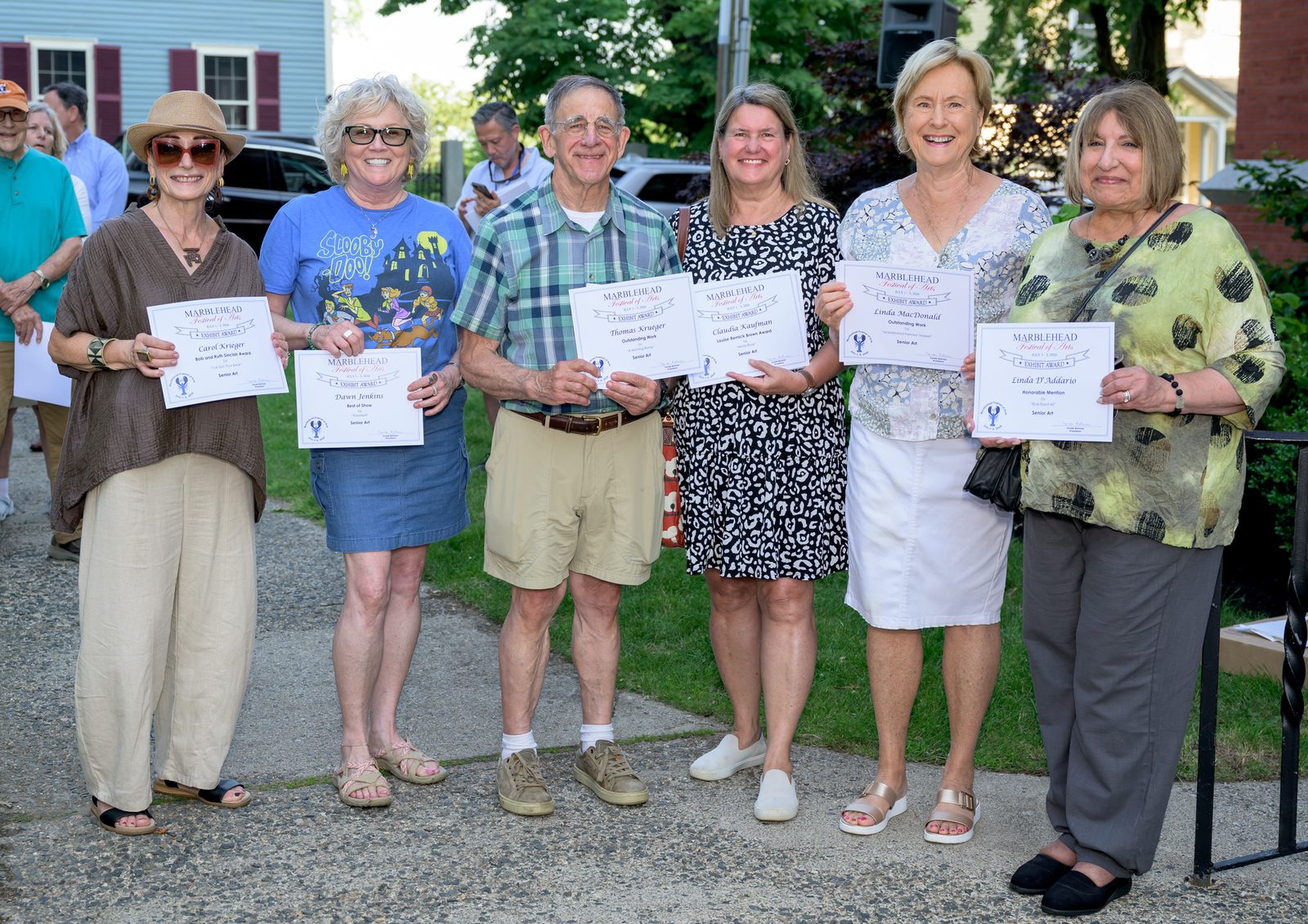 Senior Art division honorees hold their awards — Carol Krieger (Bob and Ruth Sinclair Award), Dawn Jenkins (Best of Show), Thomas Krueger, Claudia Kaufman (Louise Bernick Brown Award), Linda MacDonald and Linda D’Addario.