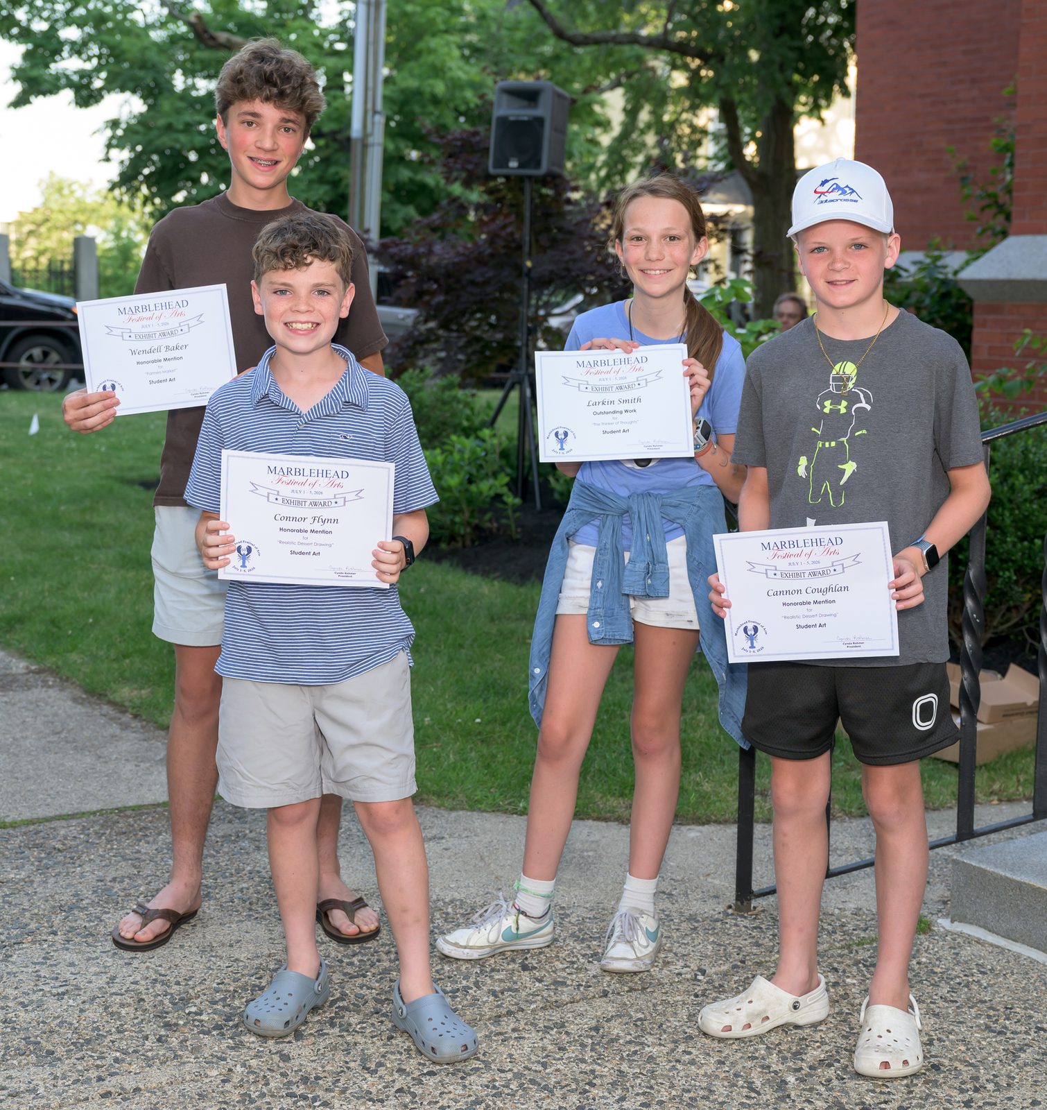 Student Art winners — Wendell Baker, Connor Flynn, Larkin Smith and Cannon Coughlan — hold up their awards.