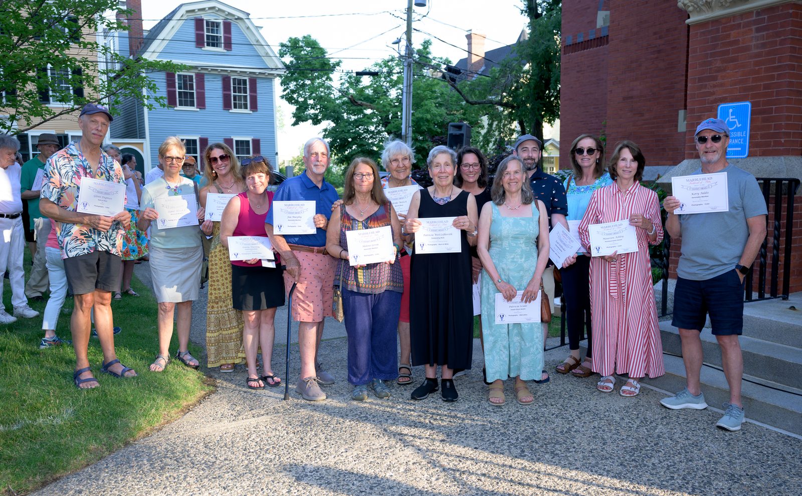 Photography category winners gather for a group portrait with their certificates outside Abbot Hall, including Joe Murphy, Patricia Weil-Lefkowitz, Maureen Askey and Kerry Addis.