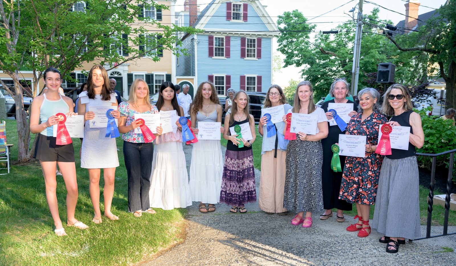 Winners of the Literary Festival awards gather with their certificates and ribbons in old town.