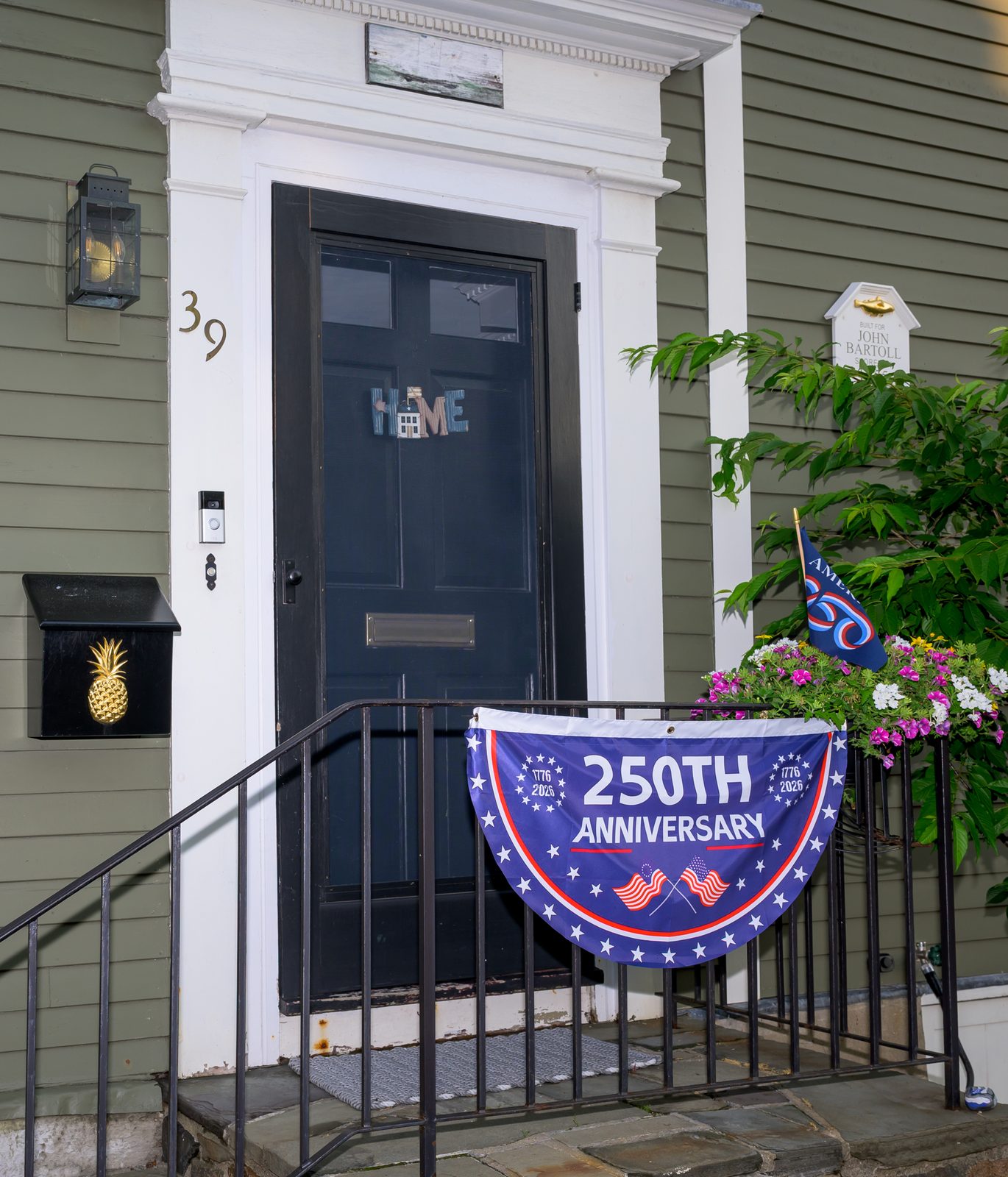 A 250th-anniversary bunting marks the semiquincentennial on the railing of a historic home in old-town Marblehead.