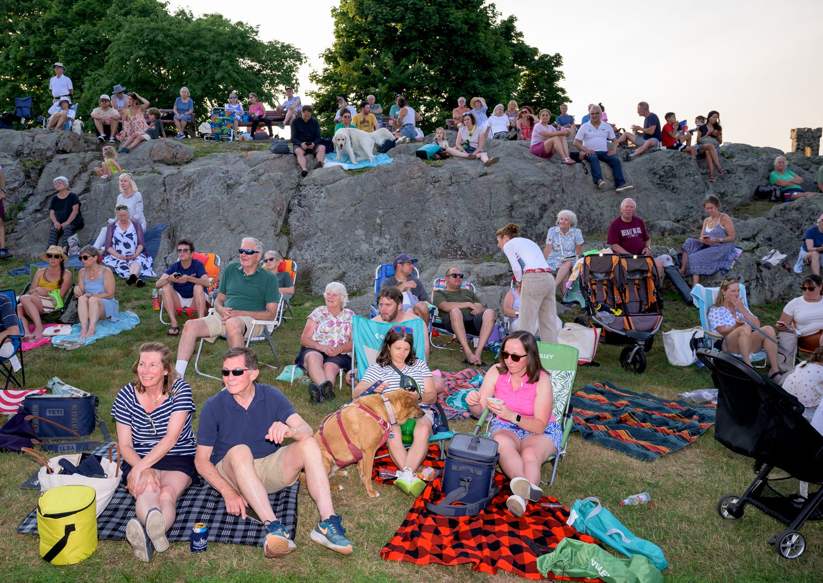 Families, neighbors and their dogs pack the ledges and lawn for an evening concert.