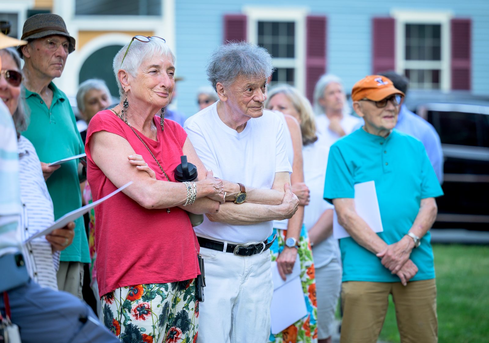 A couple links arms as neighbors gather on the lawn of a historic Marblehead home during the awards ceremony.