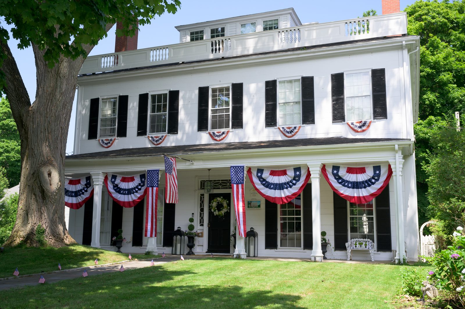 Flags and bunting drape a historic Marblehead home ahead of the Fourth of July.