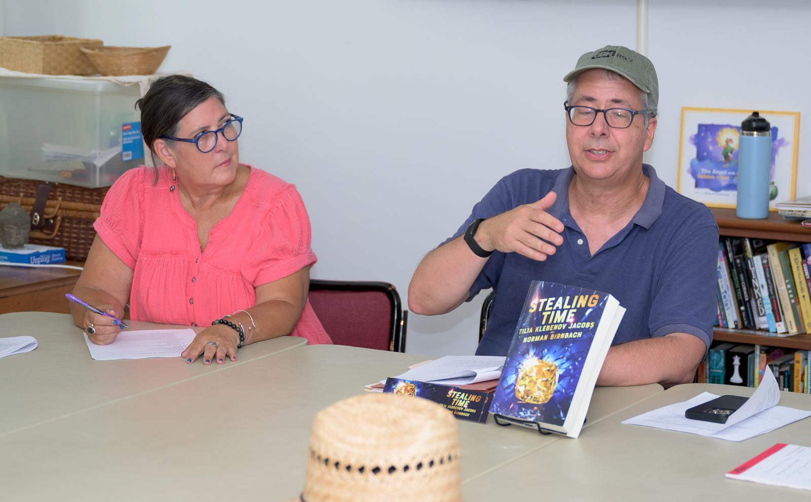 Norman Birnbach makes a point beside a display copy of his novel ‘Stealing Time’ during a writers’ session.