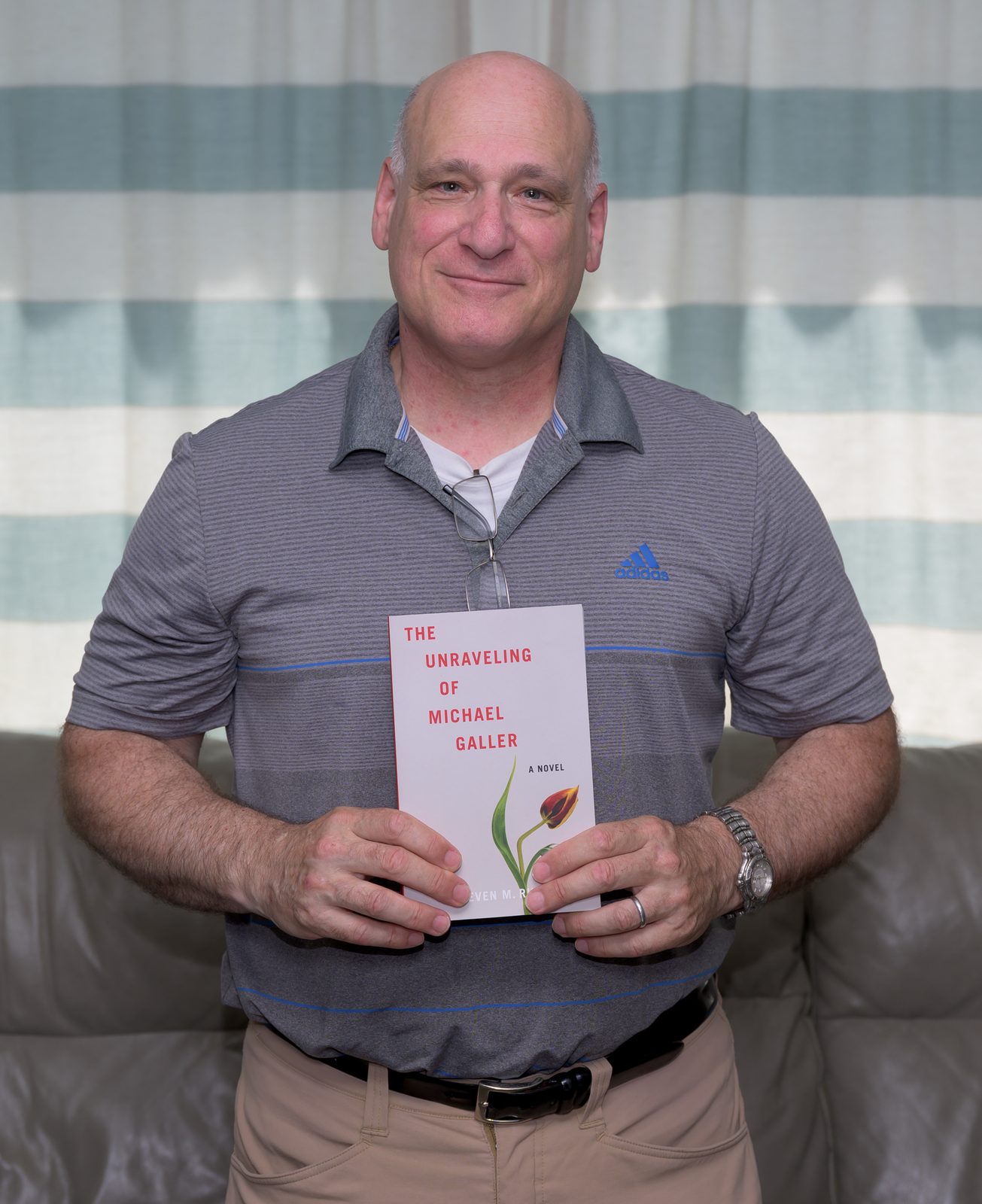 Steven M. Rubin holds his novel ‘The Unraveling of Michael Galler.’