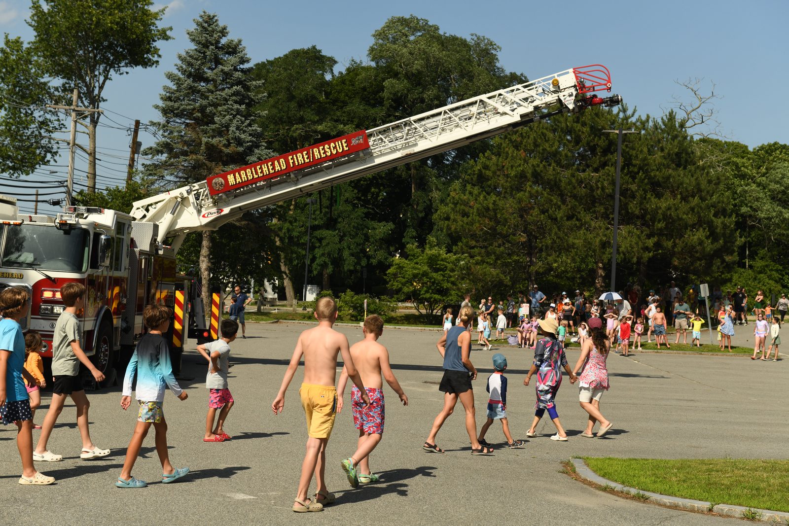 Marblehead Fire & Rescue raises its aerial ladder outside the Community Center for the department’s ‘Beat the Heat’ cool-down.