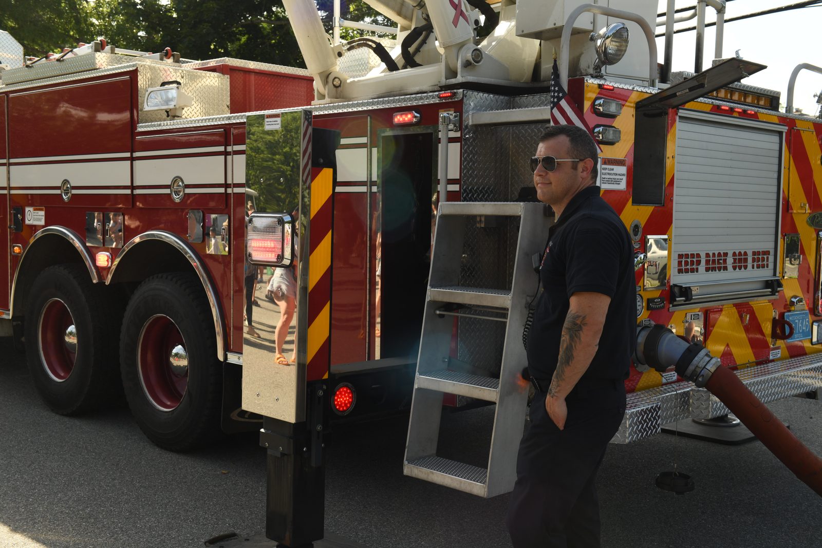 A firefighter works the pump panel of the ladder truck.