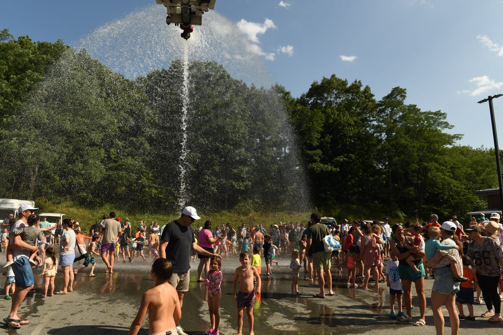 The water climbs over the lot as a crowd lines up to wait a turn.