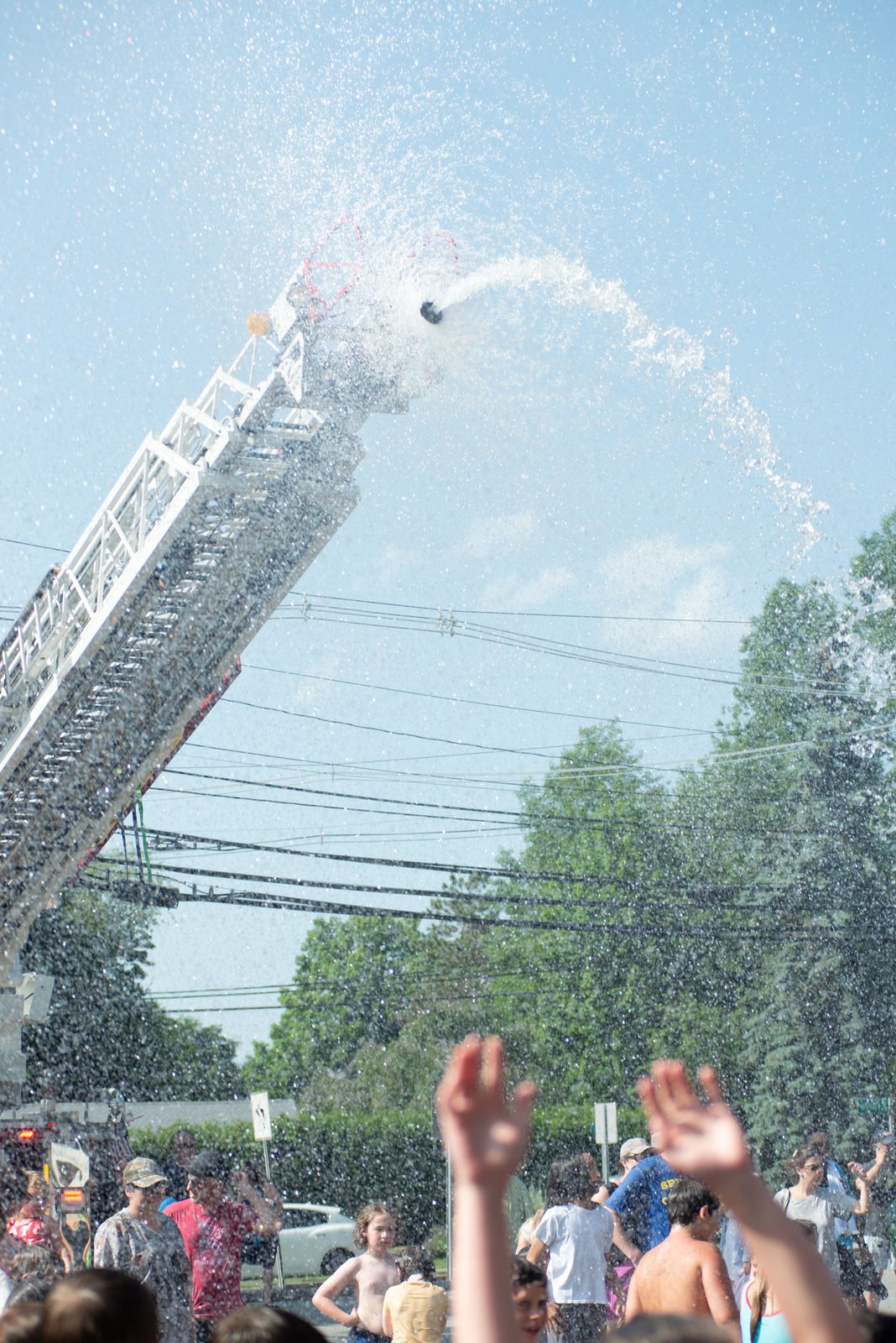 The ladder’s nozzle throws a curtain of water into the sky.