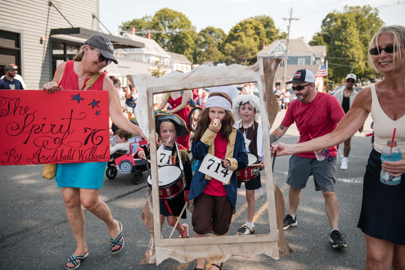Three young marchers pose as Archibald Willard’s ‘The Spirit of ’76’ inside a hand-made gold frame during the Horribles Parade.